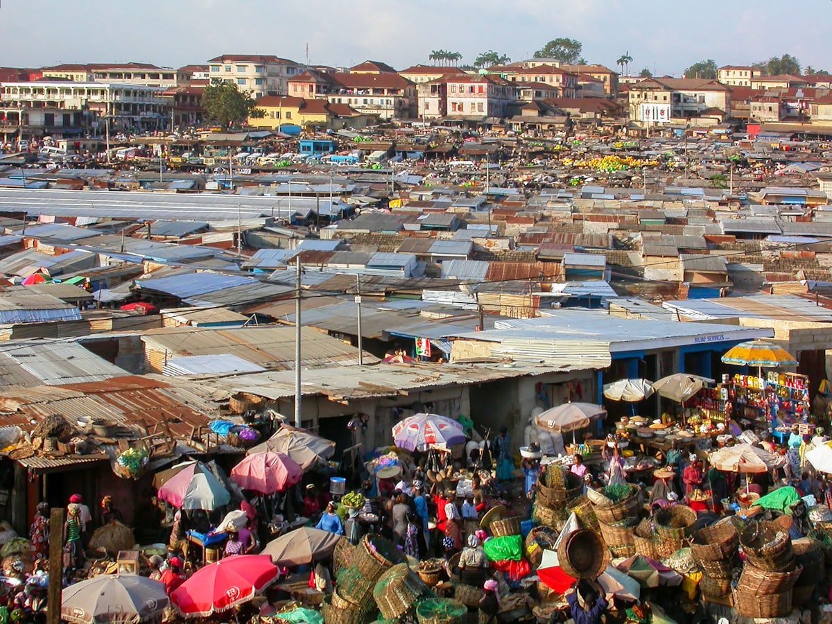 Kumasi central market from above, tin roofs and umbrella stalls