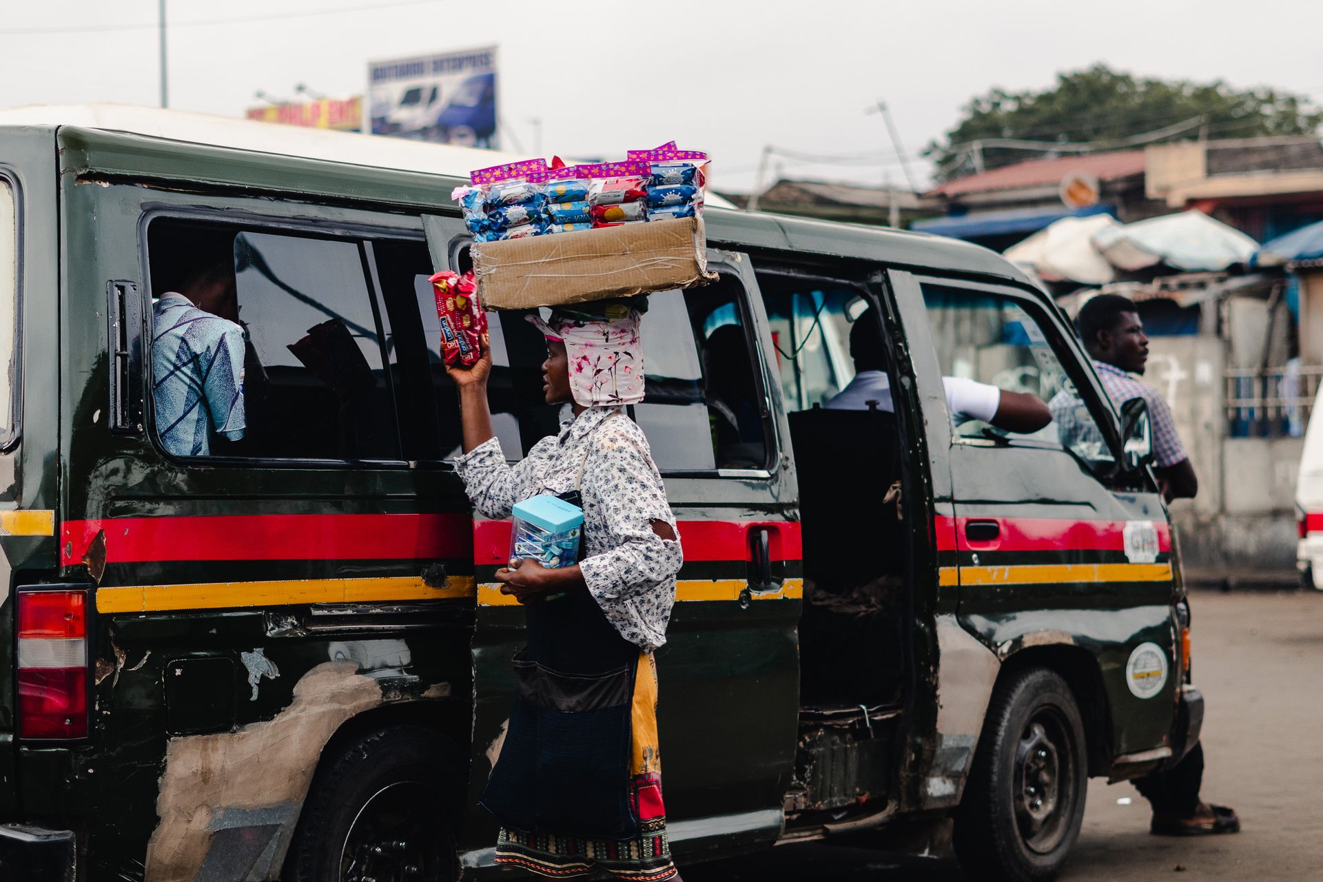 A street vendor selling snacks to tro-tro passengers in Accra, Ghana